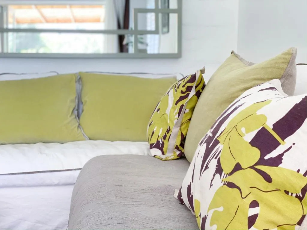 Bright lounge with lime-green sofa and patterned cushions
