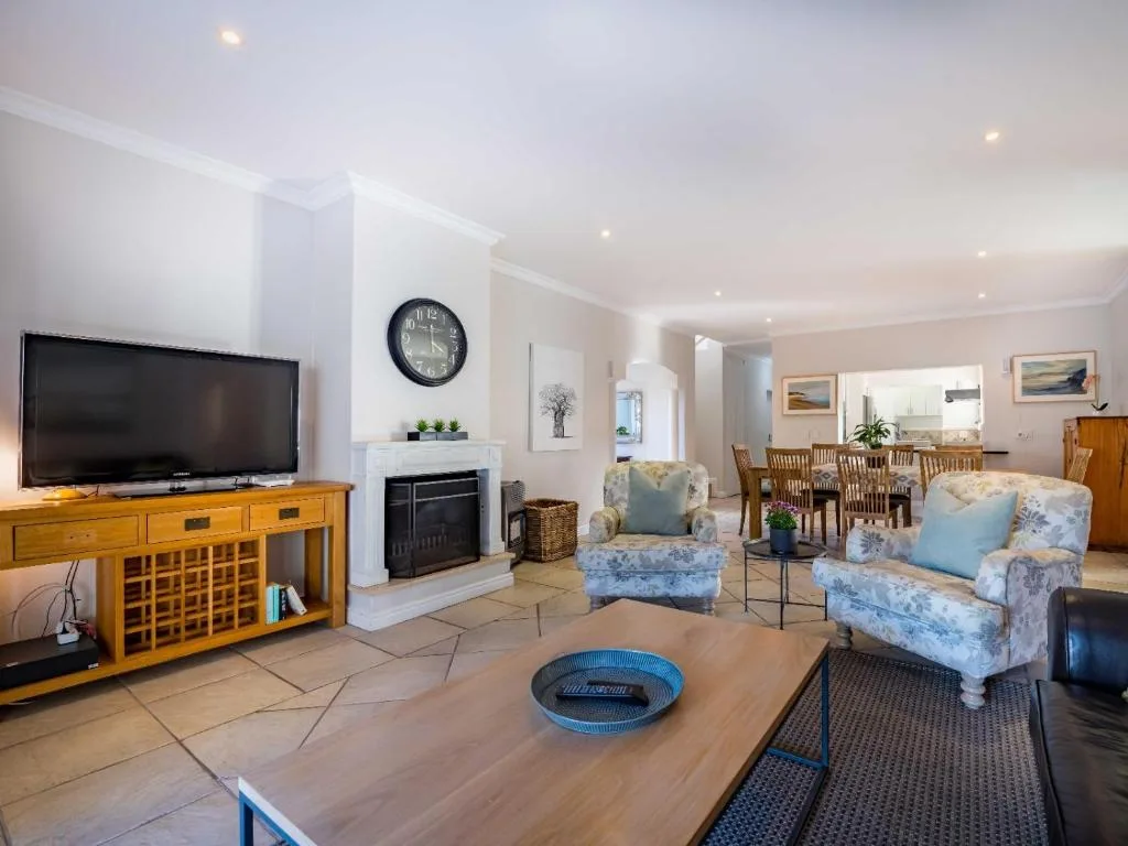 Spacious living room with fireplace, television, and comfortable seating areas