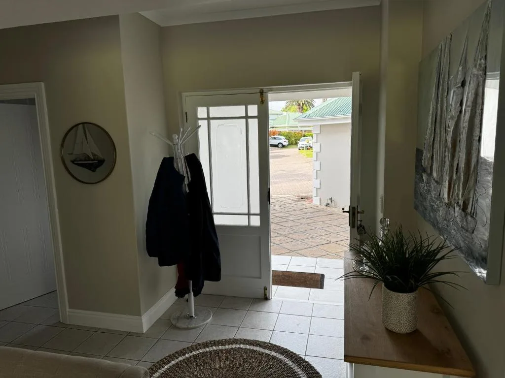 Interior entrance hall with glass doors opening to driveway and gardens