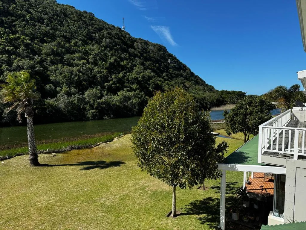 Scenic lagoon and mountain landscape with manicured grounds and landscaping