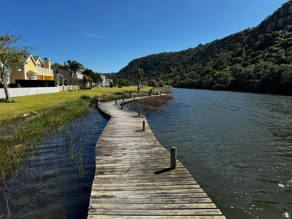 Waterfront property with lagoon views, mountains, and wooden jetty access