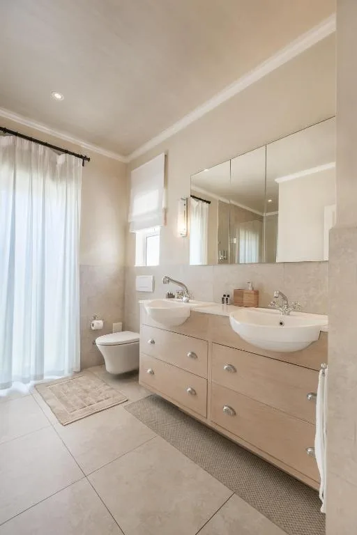 Modern bathroom with double vanity sinks and mirrored cabinet