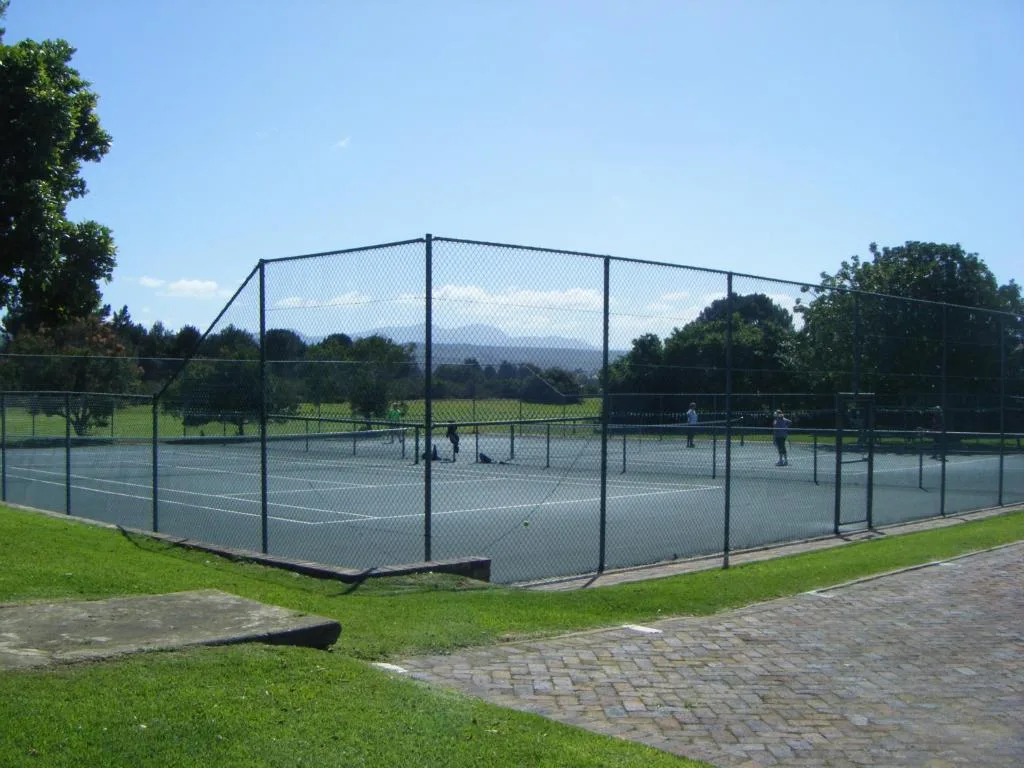 Tennis court facility with mountain views and surrounding landscaped grounds