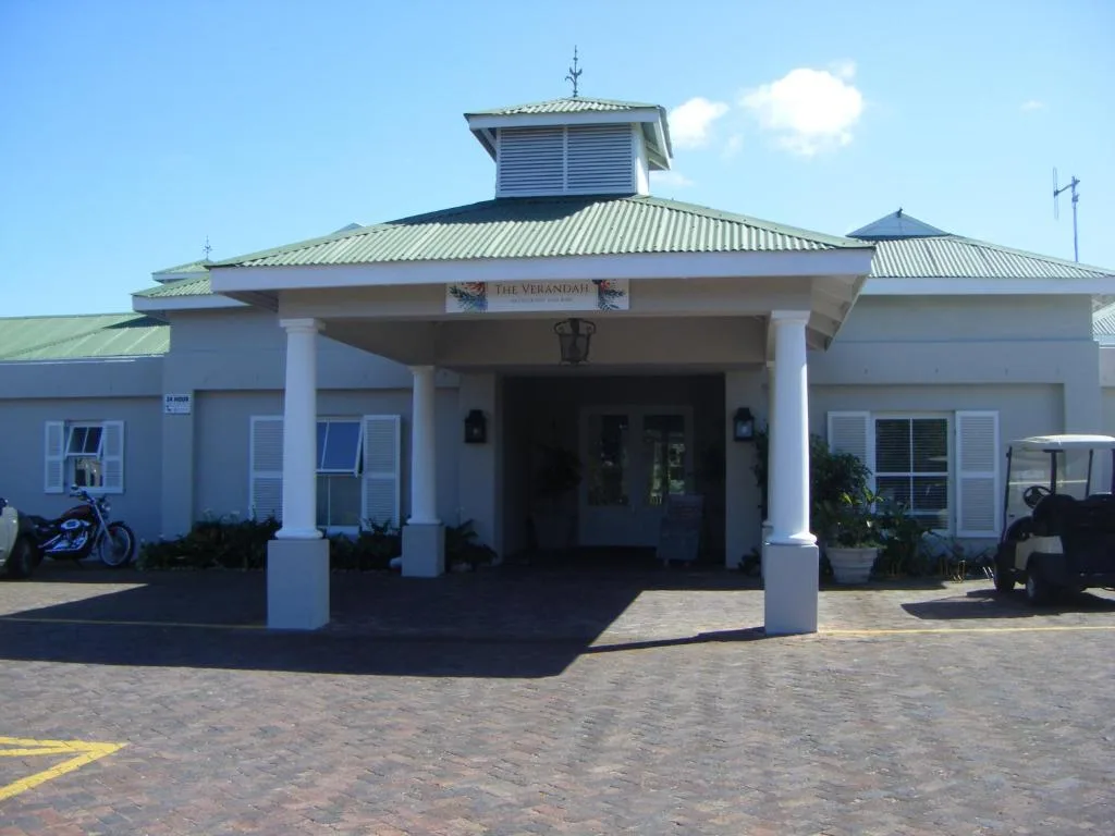 White entrance building with corrugated roof and covered portico at Goose Valley Estate