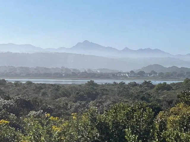 Lagoon and mountains visible across lush vegetation landscape