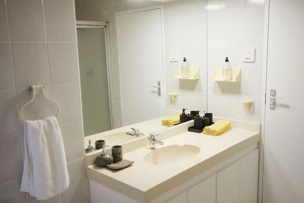 Modern bathroom with double vanity sink and large mirror
