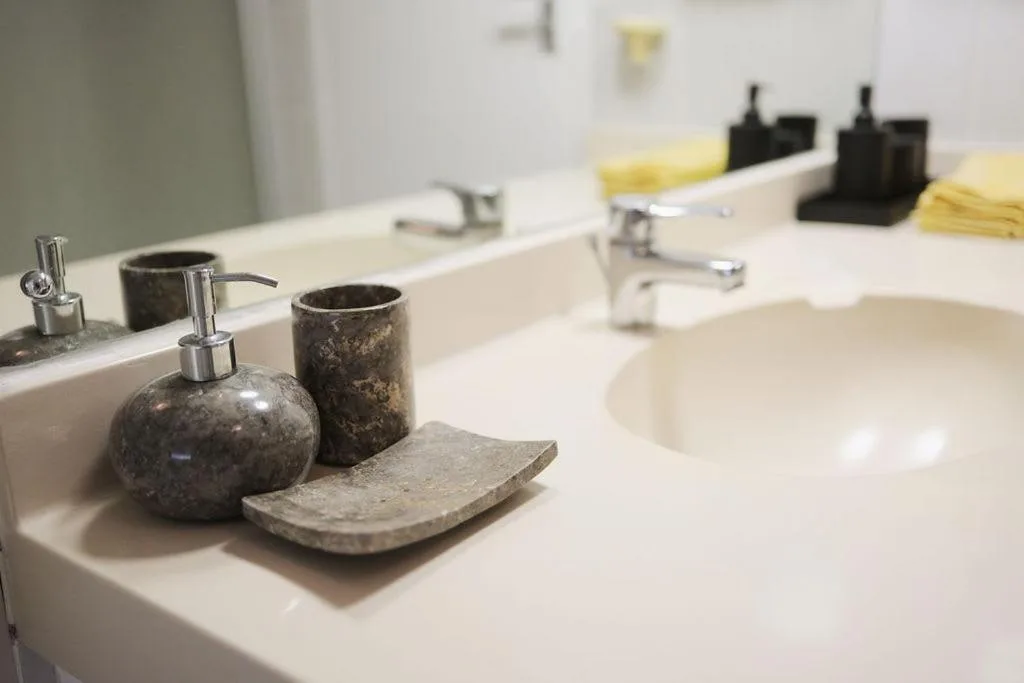 Modern bathroom vanity with decorative stone accessories and dual sinks