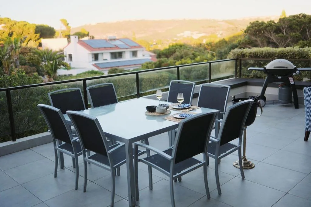 Elevated outdoor dining area with panoramic Garden Route hills and valley views