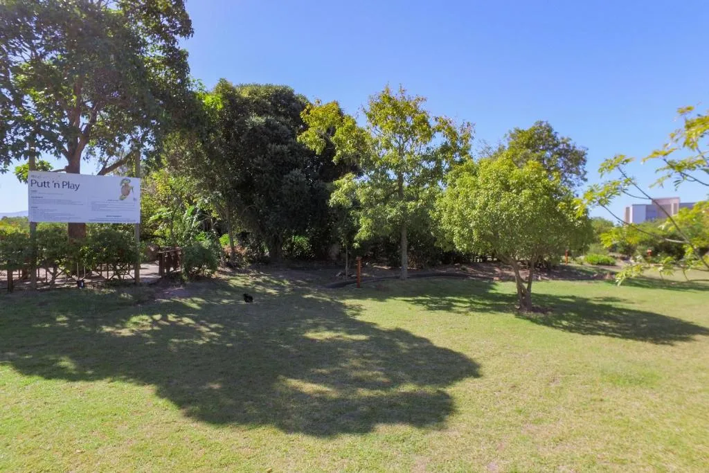 Spacious garden grounds with mature trees and manicured lawn