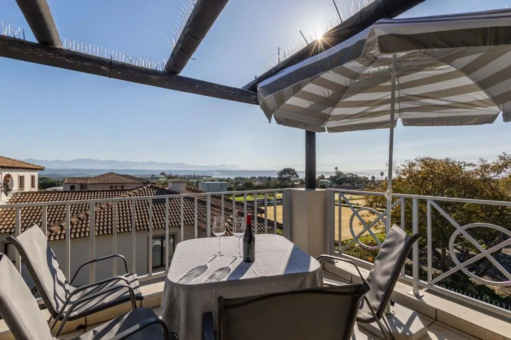 Shaded outdoor dining area with mountain views and patio furniture
