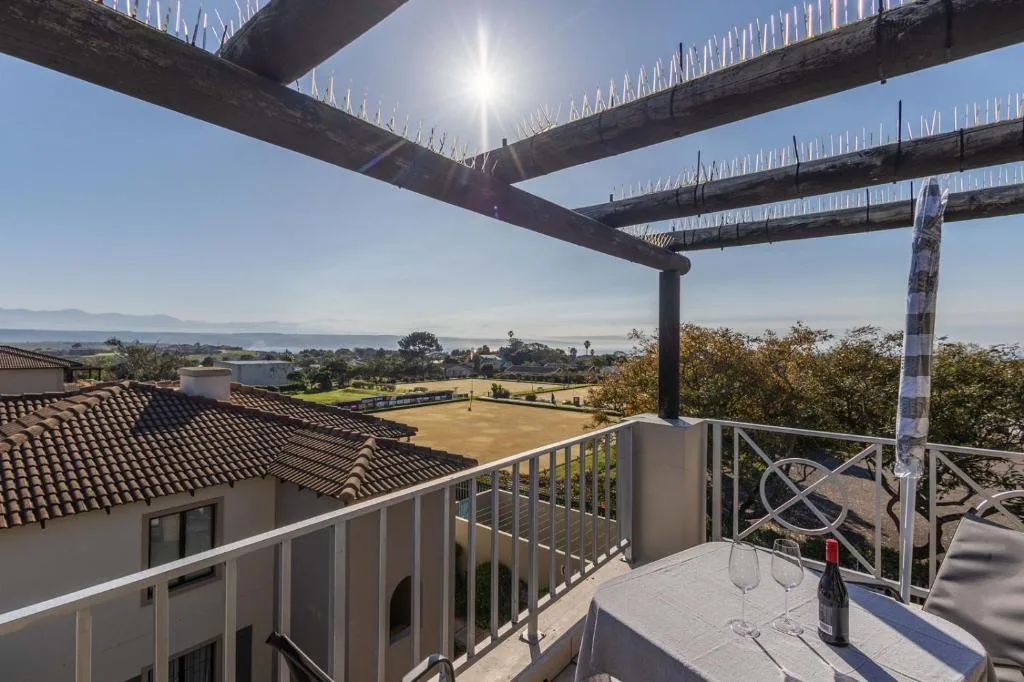 Elevated deck with pergola overlooking lagoon and mountains beyond