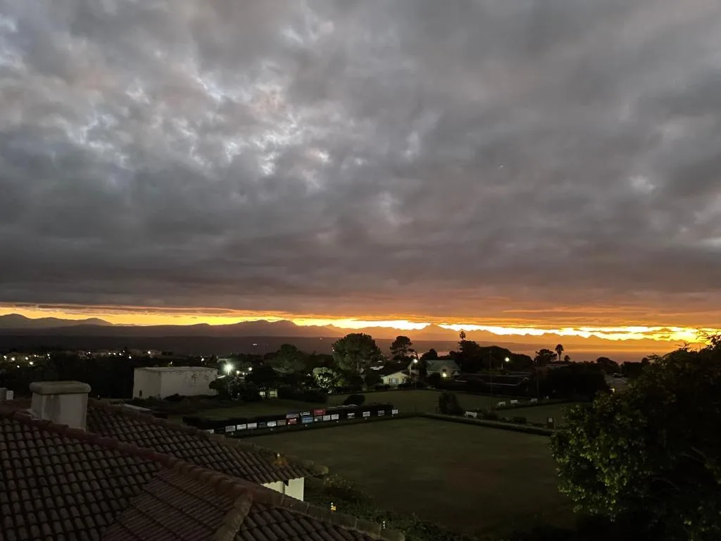 Dramatic sunset over mountains and valley landscape from property