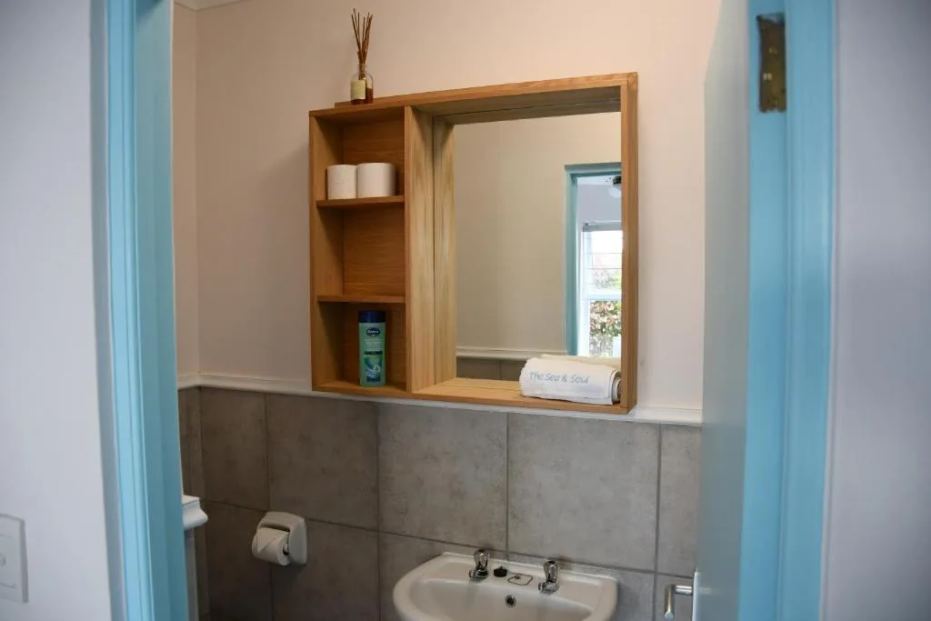 Bathroom vanity with wooden mirror cabinet and storage shelves