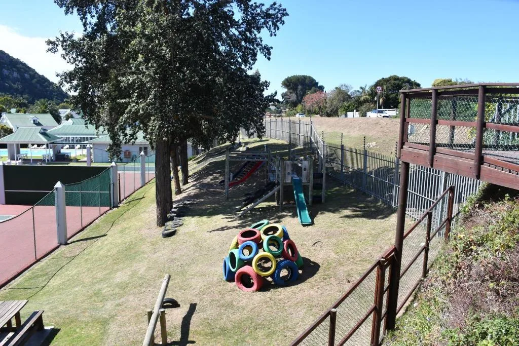 Colorful children's playground with climbing structures and tire obstacles