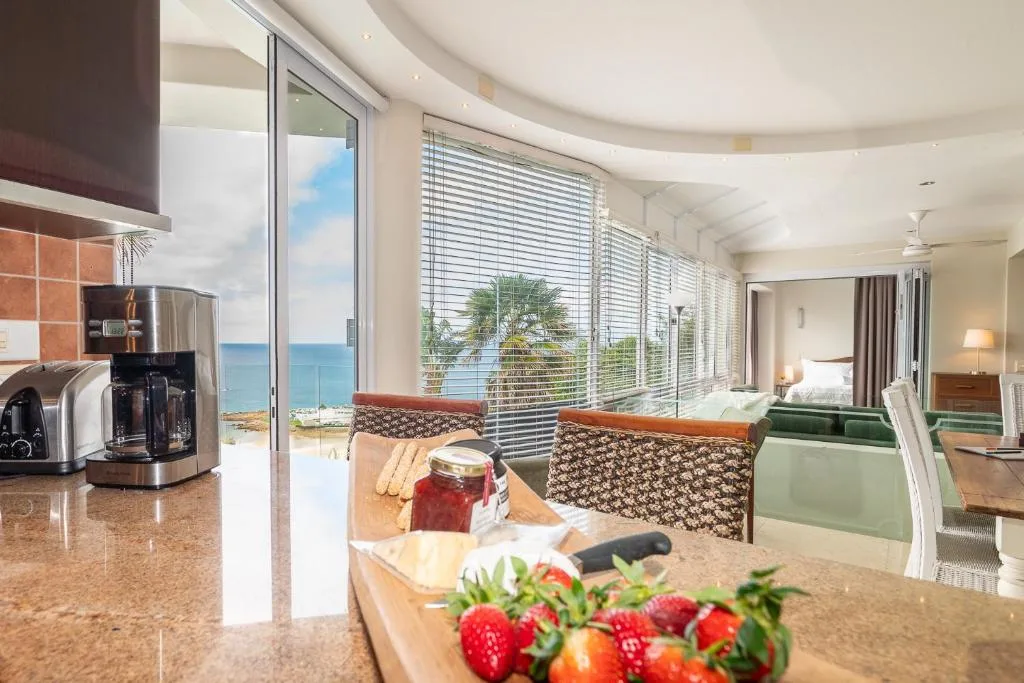 Modern kitchen with ocean views, fresh berries on counter, stainless steel appliances