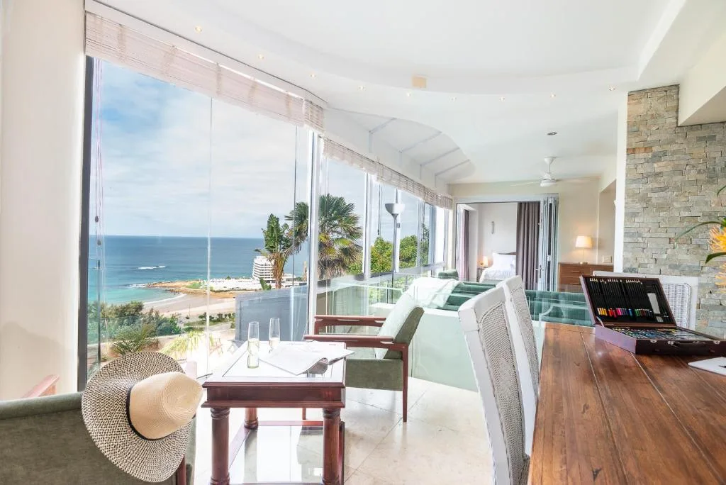 Bright lounge with ocean views through floor-to-ceiling windows and contemporary furnishings