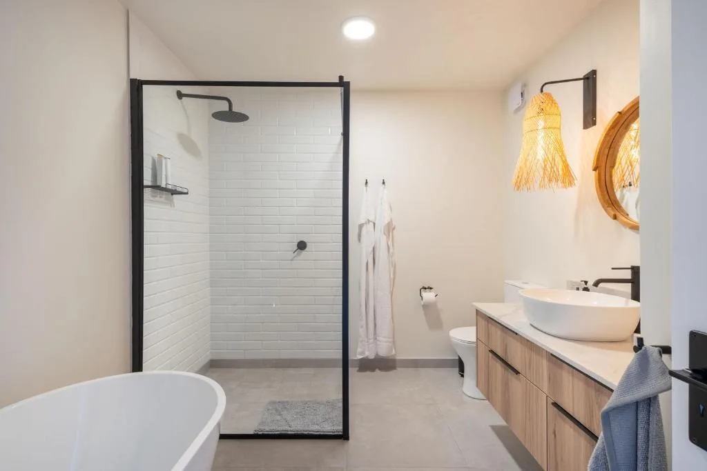 Modern bathroom with freestanding tub, walk-in shower, and dual vanity
