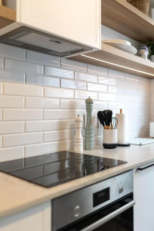 Modern kitchen with white subway tile backsplash and stainless steel appliances