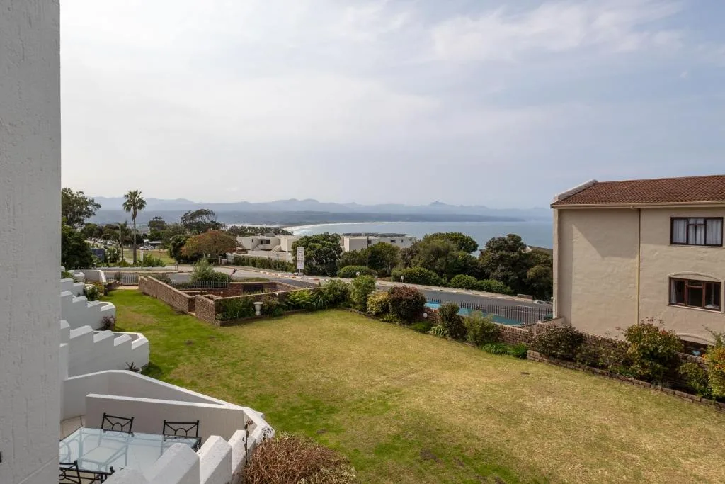 Expansive lagoon view across manicured gardens and neighboring properties