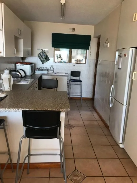 Modern kitchen with stainless steel appliances and granite countertop seating