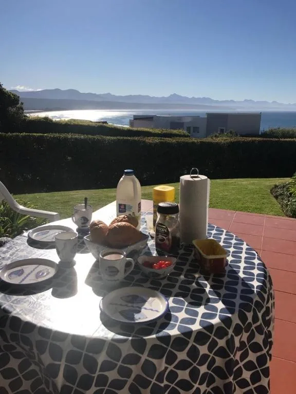 Stunning coastal mountain vista from garden seating area with breakfast setup