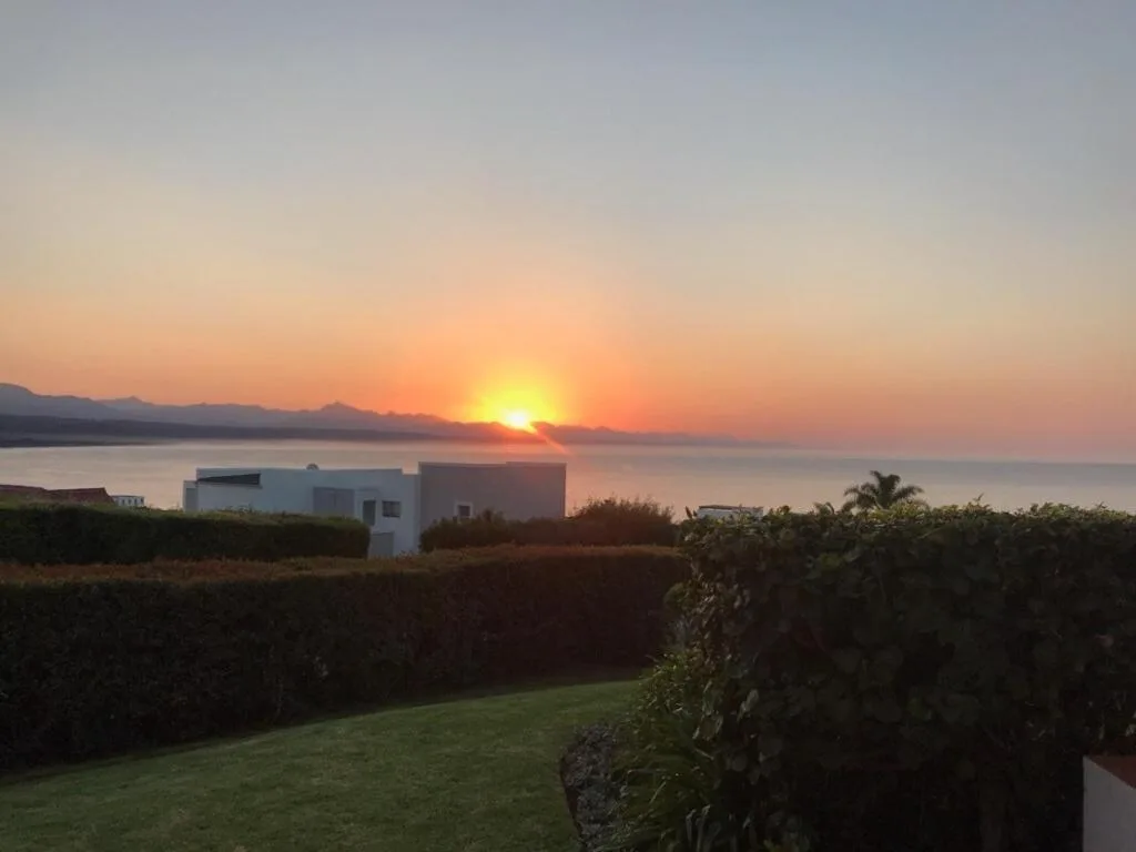 Sunset over Plettenberg Bay with mountains and ocean horizon visible