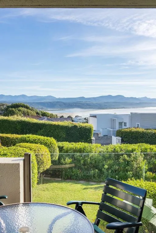 Panoramic lagoon and mountain vista from a Garden Route property deck