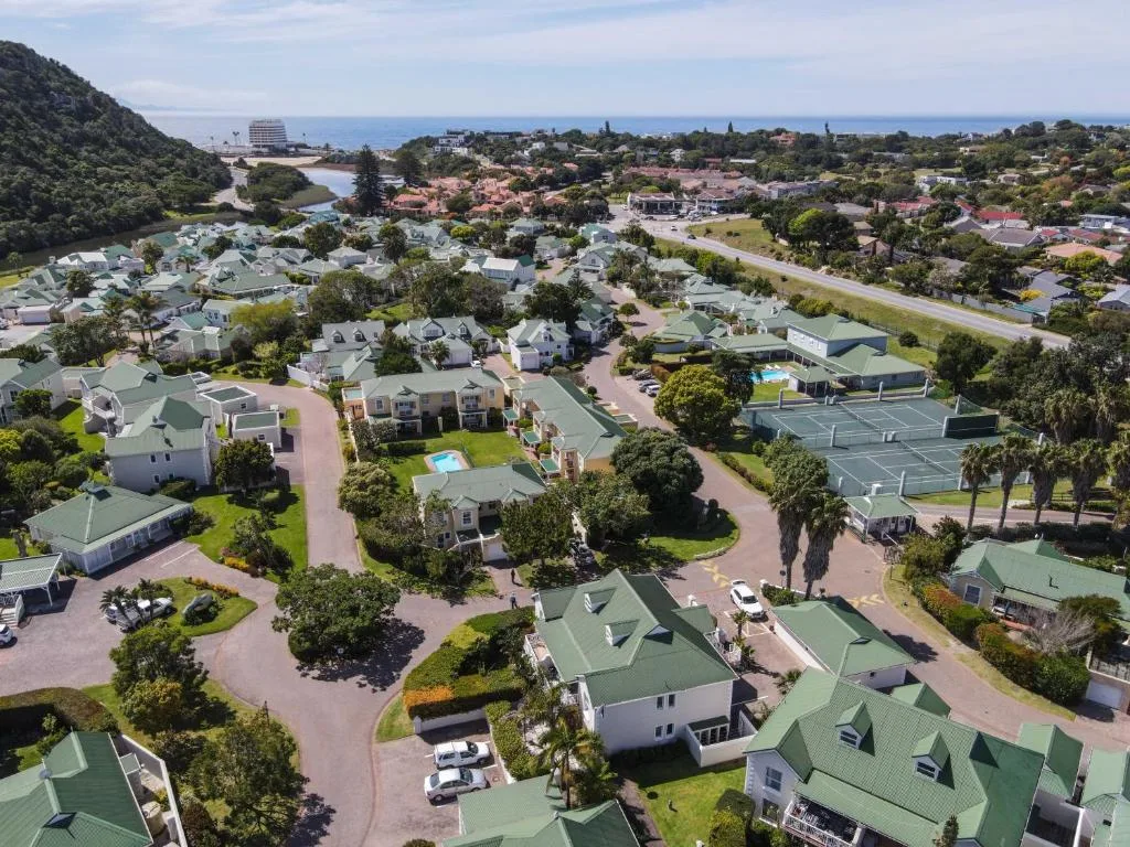 Aerial view of coastal town with ocean and lagoon in distance