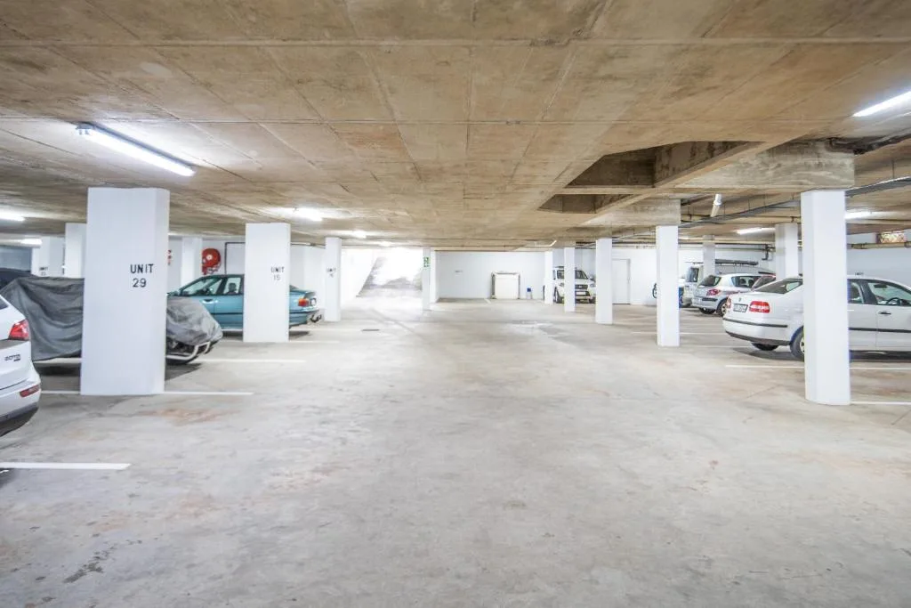 Underground parking garage with numbered spaces and support columns