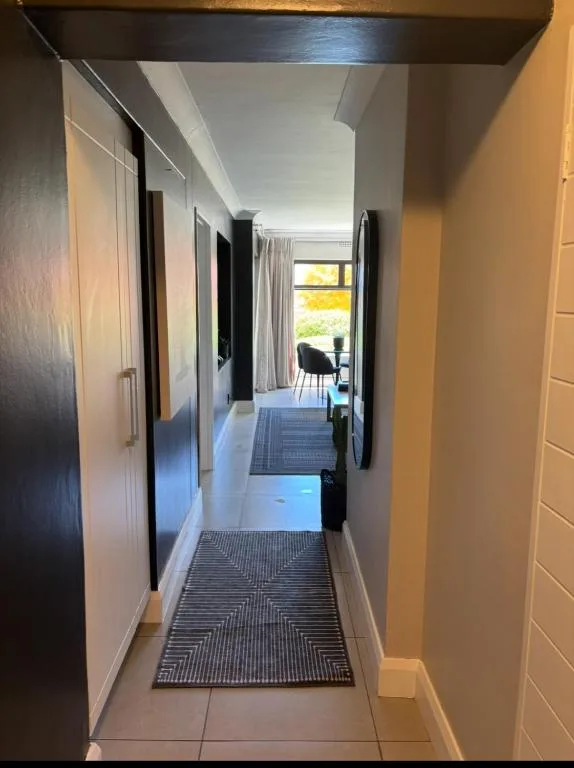 Modern hallway with geometric patterned runner and multiple dark doors