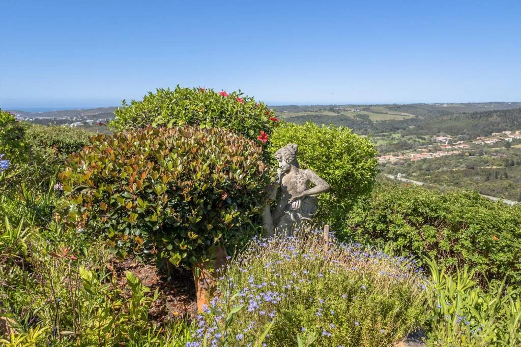 Panoramic landscape view of rolling hills and coastal terrain from garden