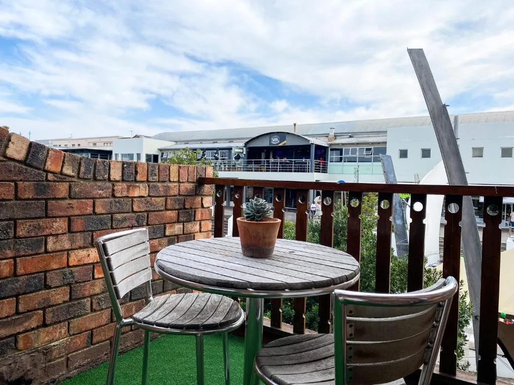 Outdoor seating area with round table and chairs on rooftop deck