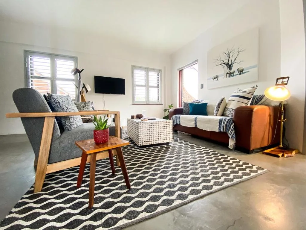 Bright living room with comfortable seating, geometric patterned rug, and modern decor