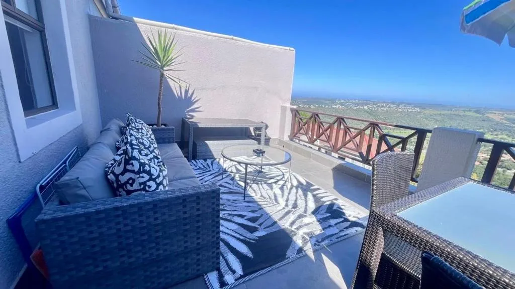 Elevated outdoor patio with comfortable seating and sweeping landscape views