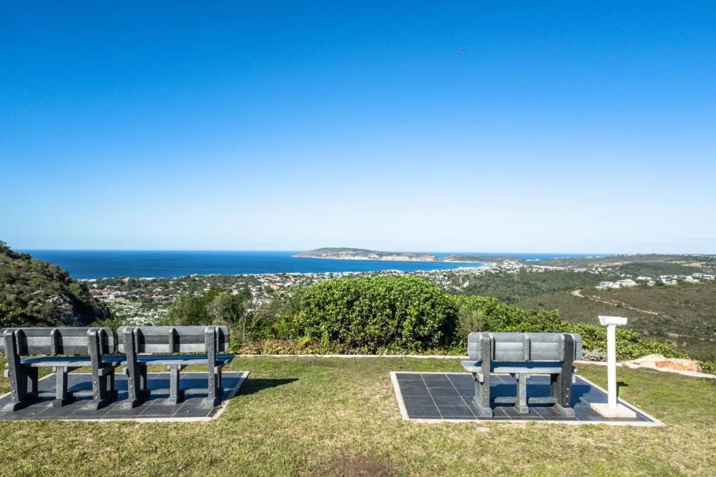 Sweeping coastal view of Plettenberg Bay with ocean, islands, and lush vegetation