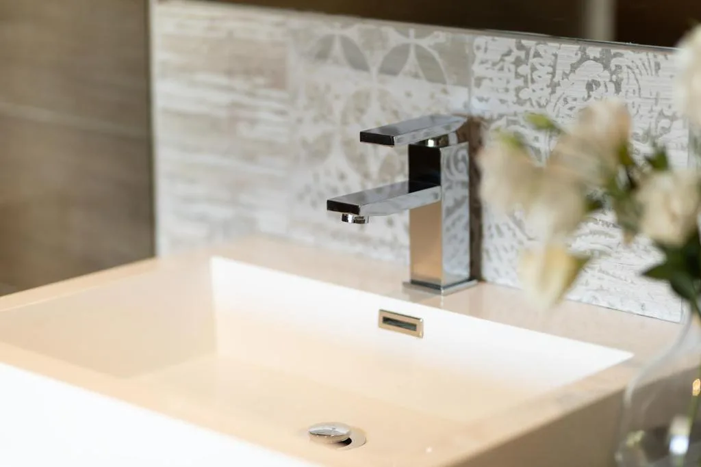 Modern bathroom vanity with sleek chrome faucet and white sink basin