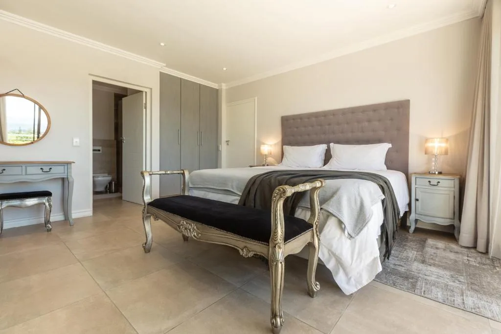 Spacious bedroom with upholstered headboard bed and elegant furnishings