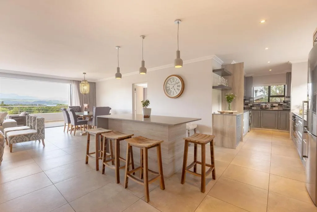 Modern open-plan kitchen with island seating and pendant lighting fixtures