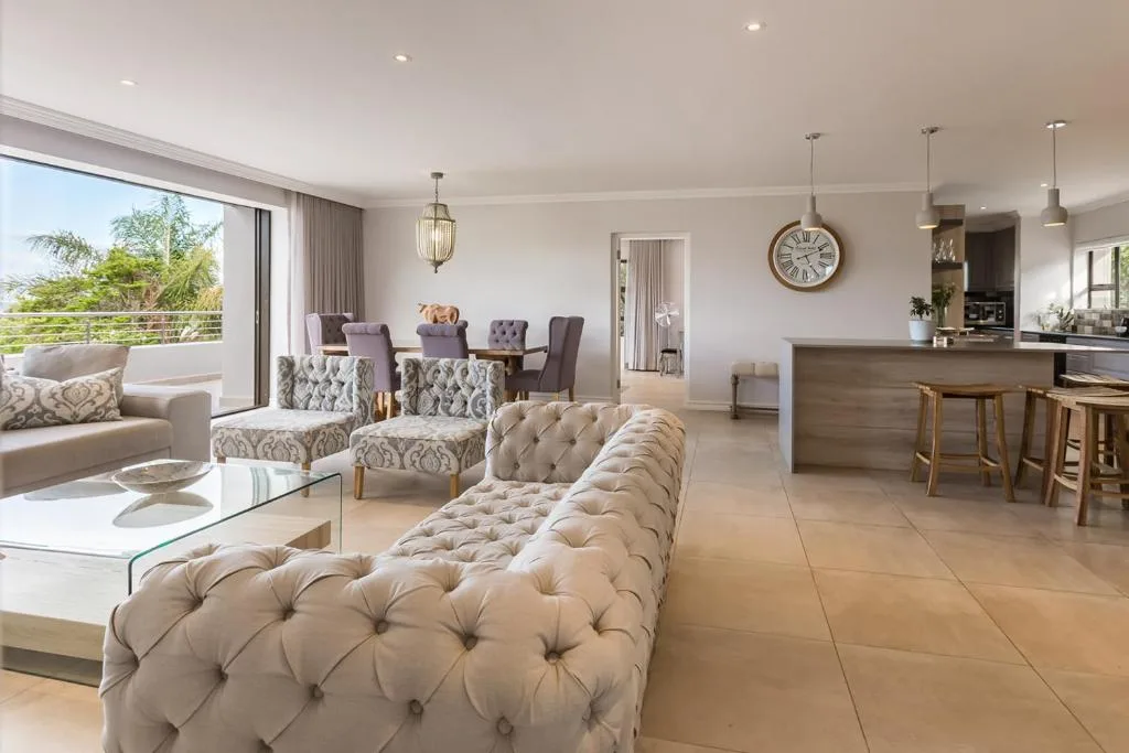 Spacious open-plan lounge with modern furnishings and garden views