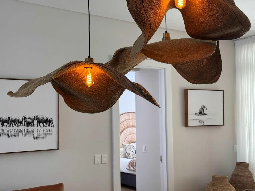 Artistic wooden pendant lights with warm bulbs illuminate modern interior