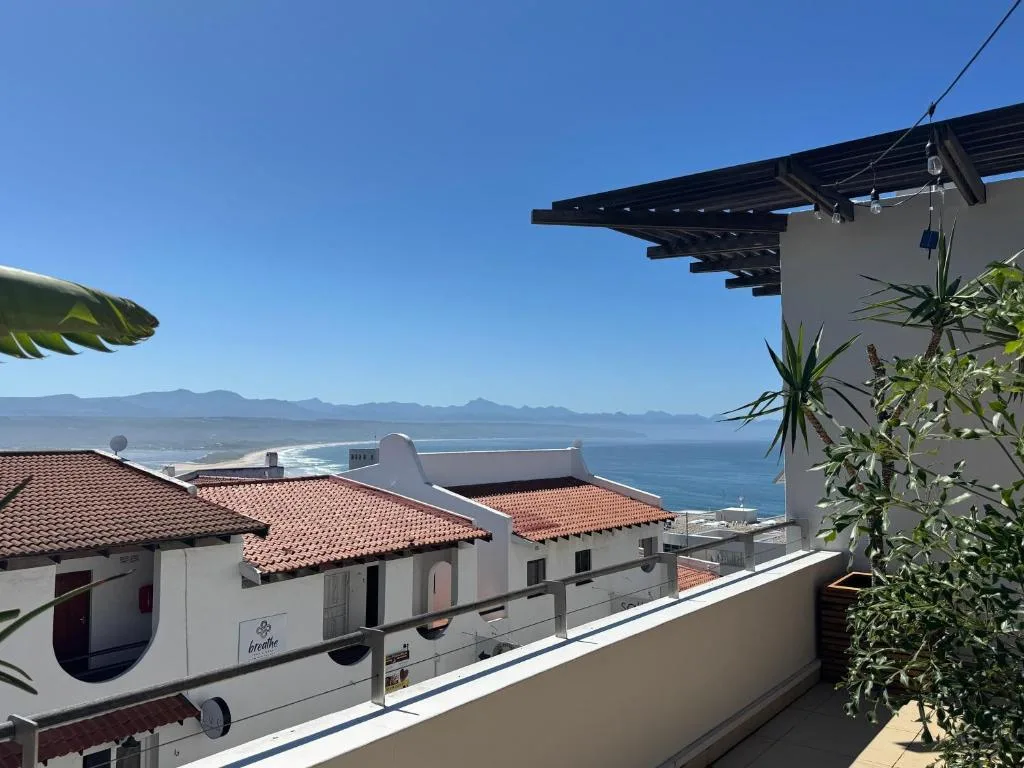 Panoramic ocean and mountain view from seaside property deck overlooking Plettenberg Bay