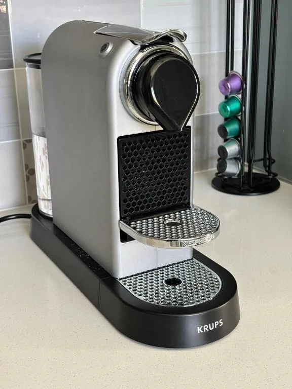 Krups coffee machine with capsule holder on kitchen counter