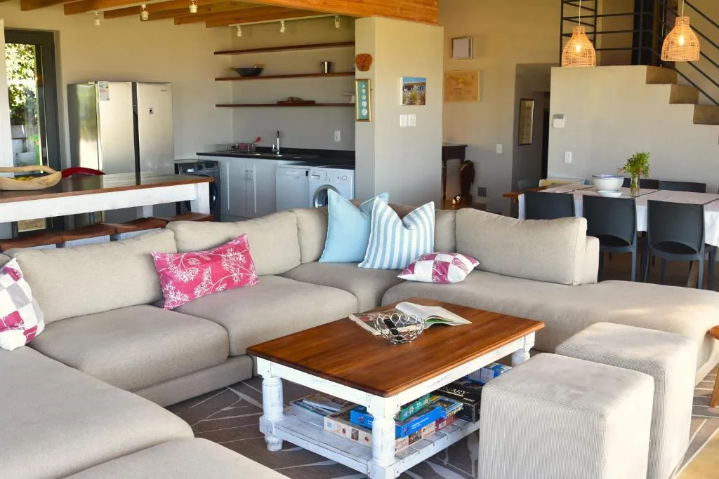 Open-plan living room with cream sectional sofa and wooden coffee table