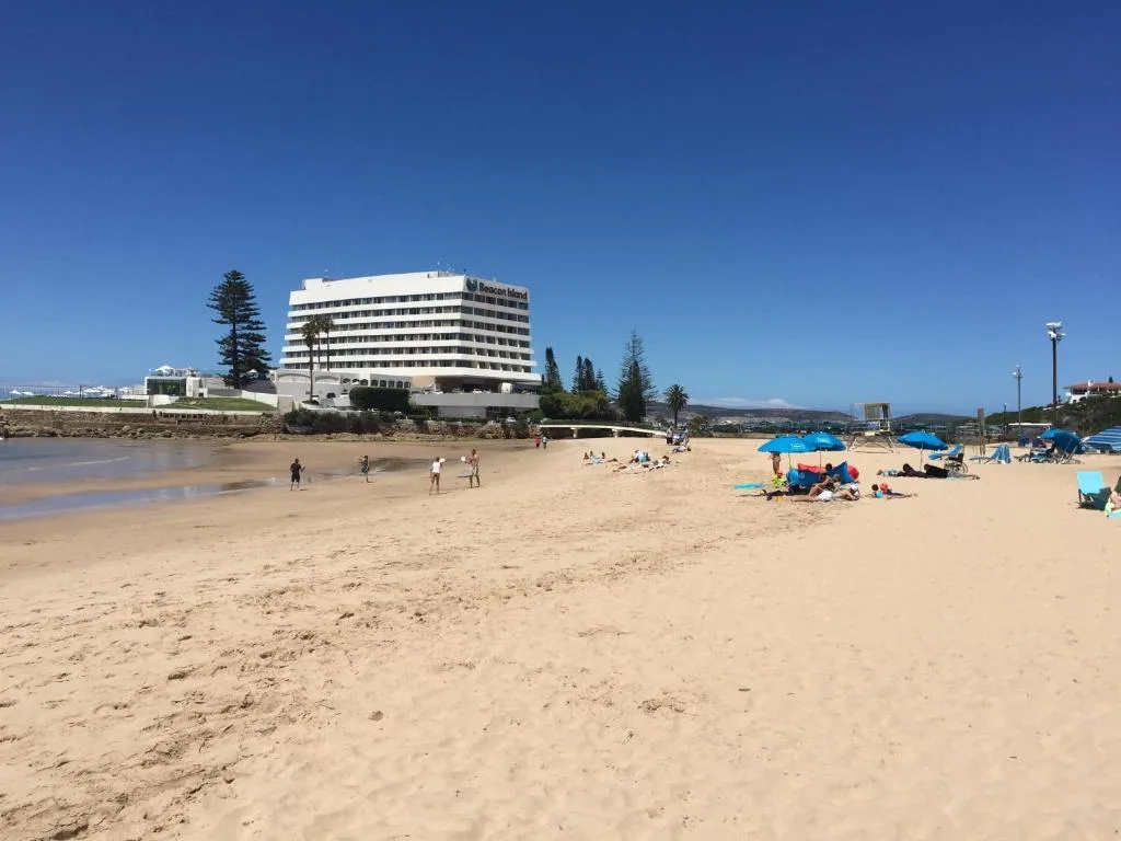 Sandy beach with ocean and mountains visible from property location