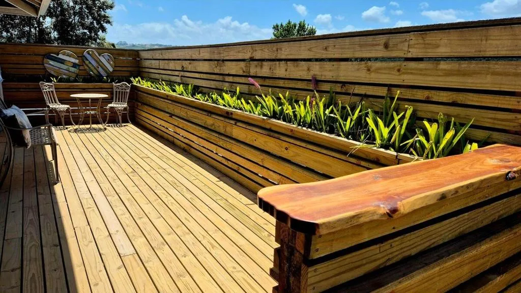 Wooden deck with seating area, planters, and mountain views