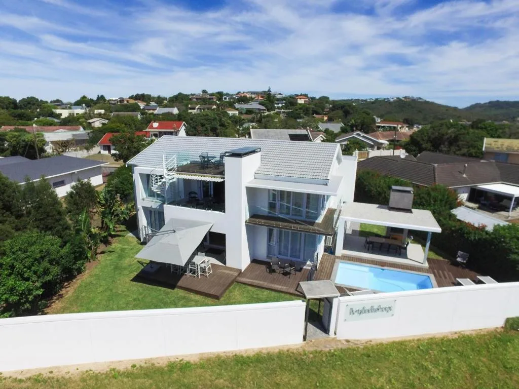 Modern white villa with pool overlooking Plettenberg Bay suburb landscape