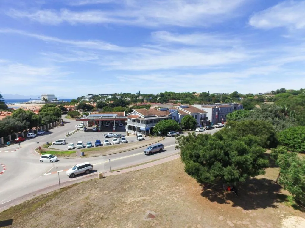Aerial view of Plettenberg Bay town with ocean and mountains beyond