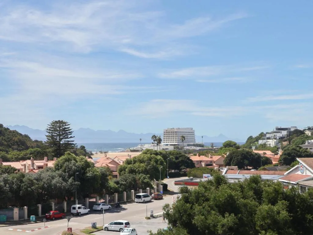 Scenic coastal view of Plettenberg Bay with ocean, mountains, and beachfront hotels