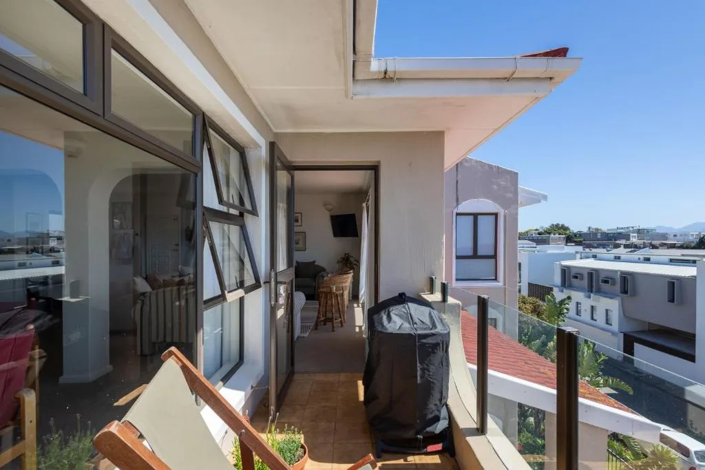 Covered rooftop terrace with braai area and mountain views