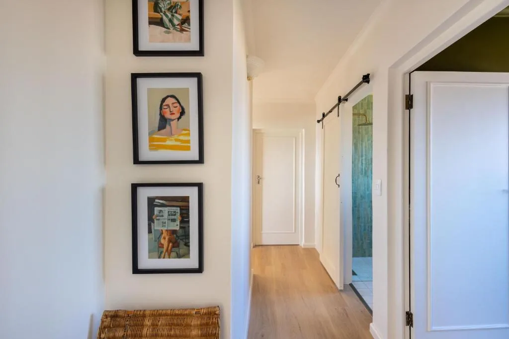 Hallway with framed artwork and woven basket decor